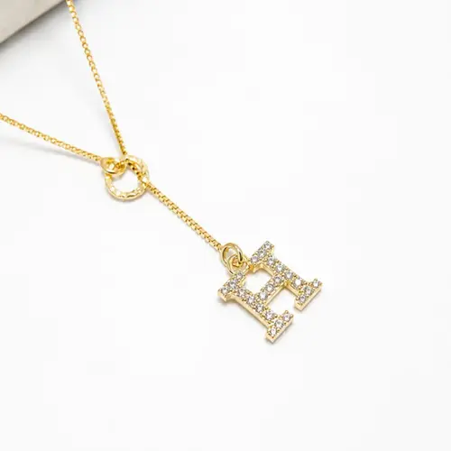 GRAVATA LETRA BANHADA A OURO 18K