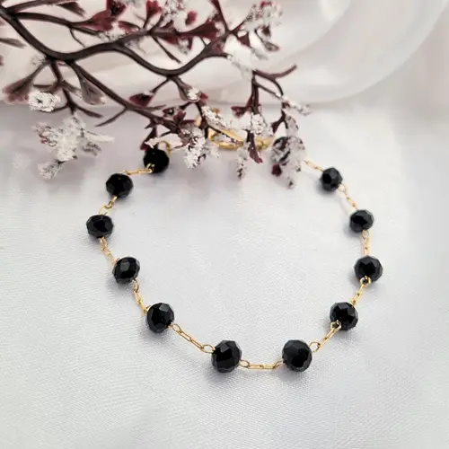 PULSEIRA BOLAS NEGRAS BANHADA A OURO 18K